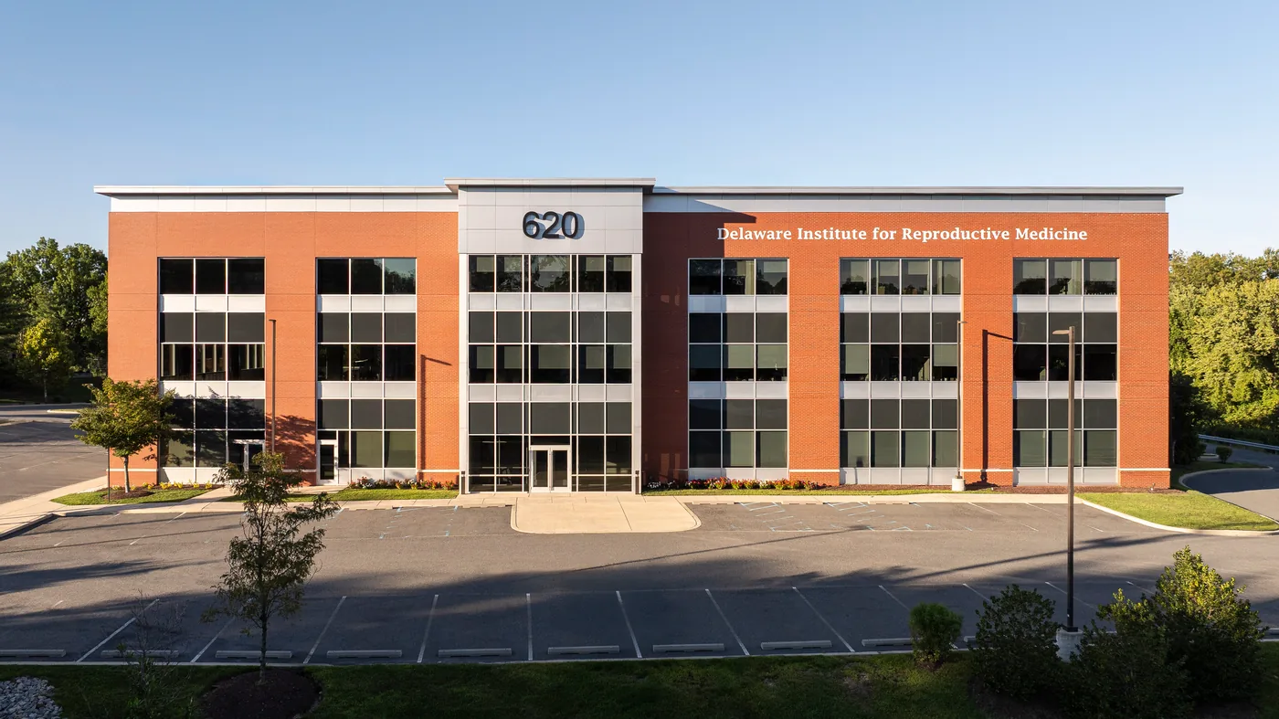 Elevated view of the three story brick and glass medical office building at golden hour