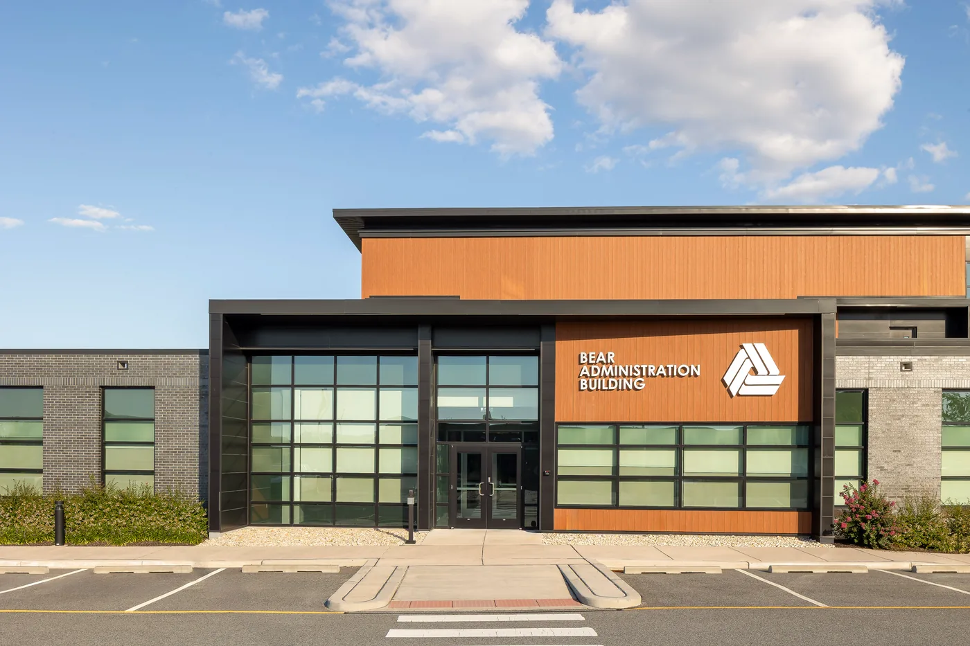 Entrance of the Bear Administration Building, wood look cladding above a black steel and glass entry