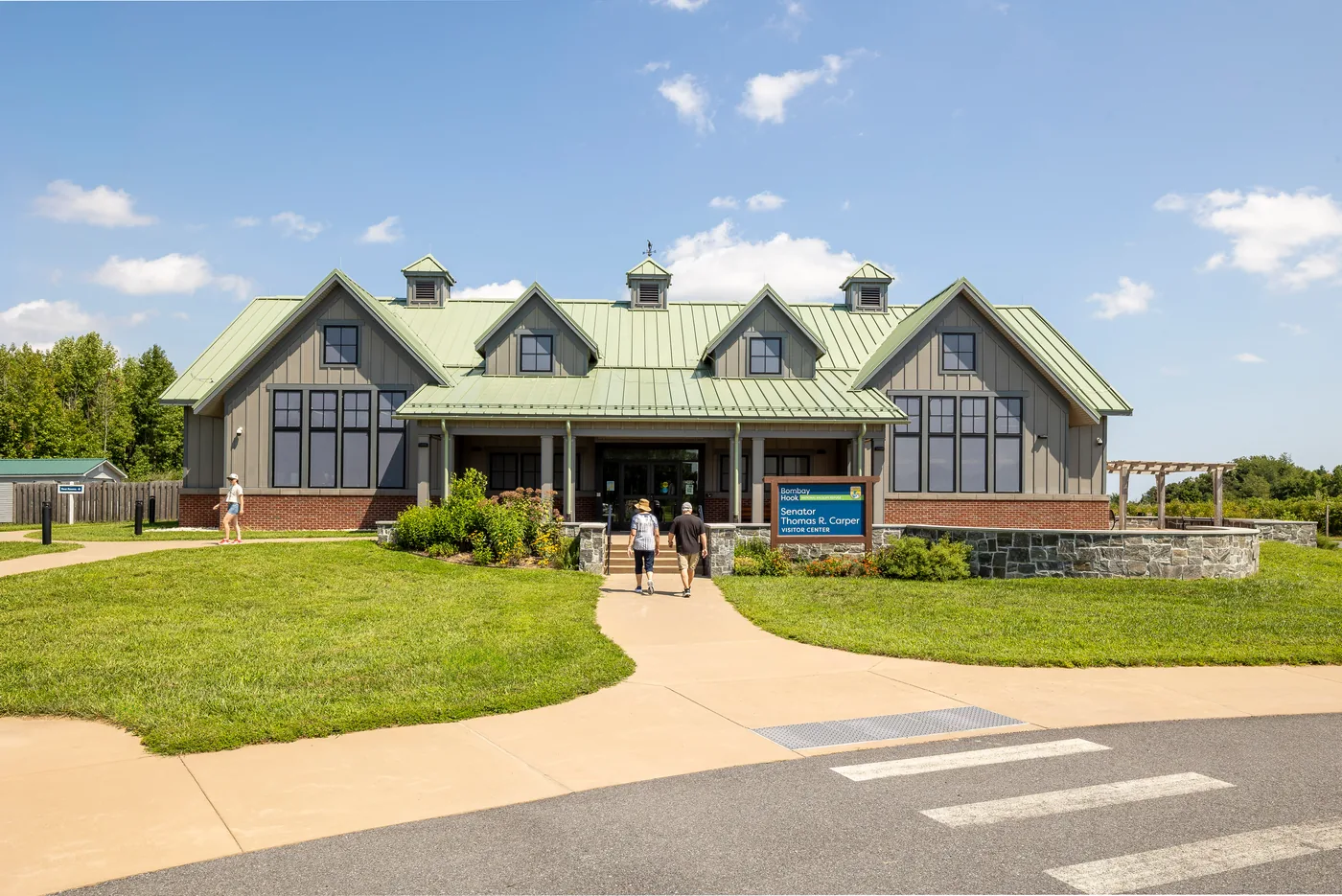 Visitors walking up the path to the visitor center entrance