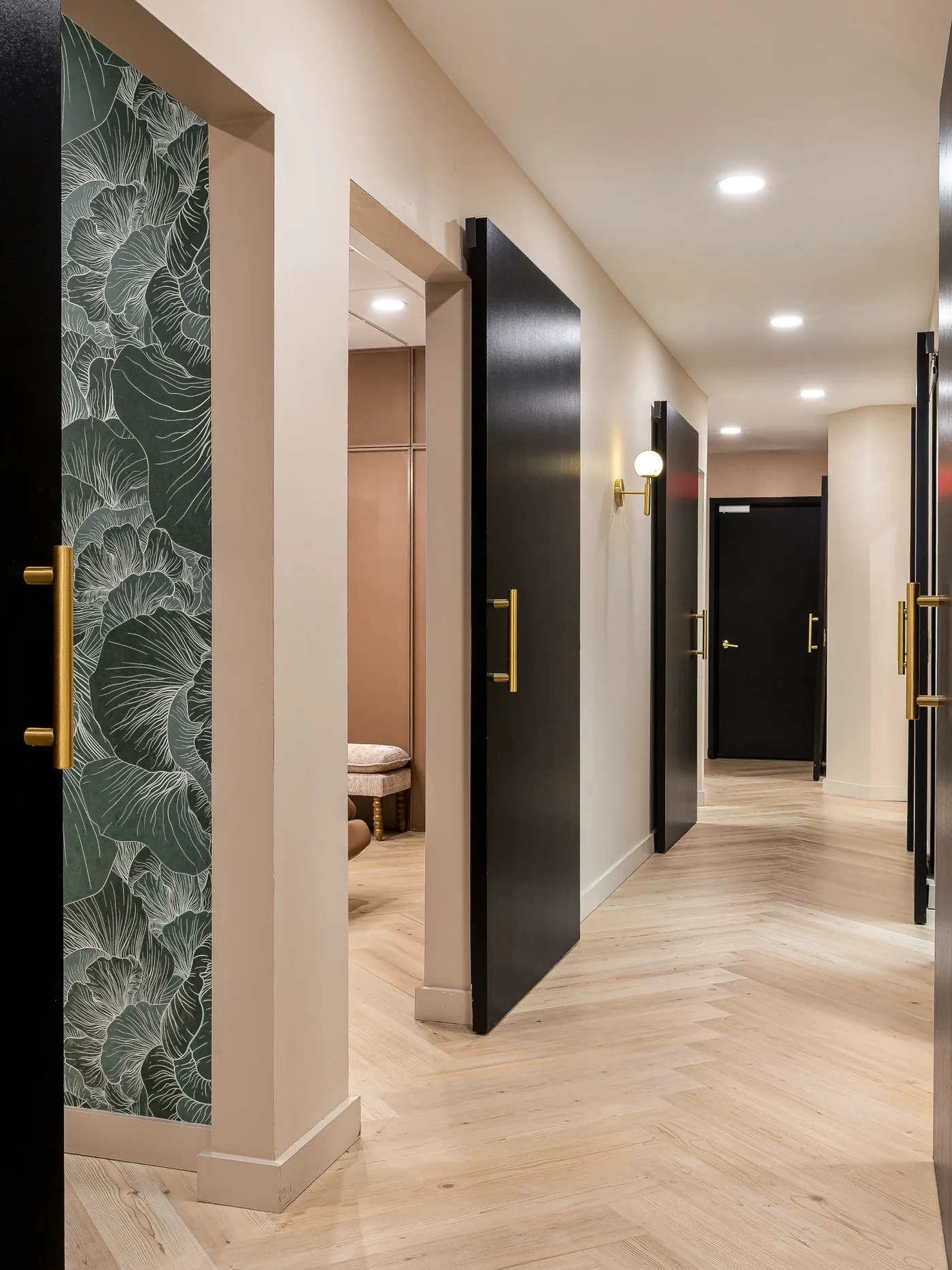 Spa corridor with botanical wallpaper and black doors