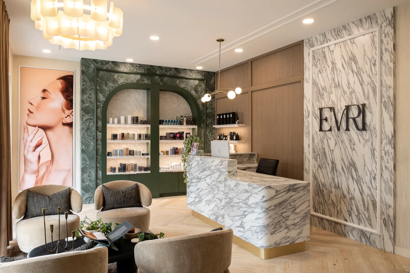 Med spa reception with a marble desk and arched green millwork