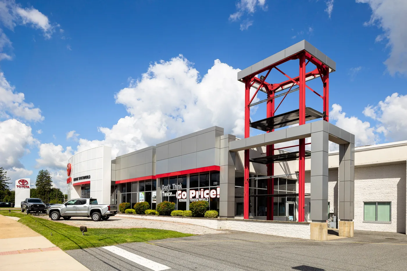 Dealership frontage with a red steel tower element