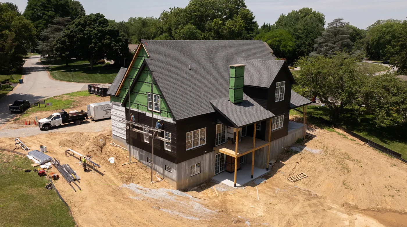 Aerial of the new home mid build, with the site graded around it