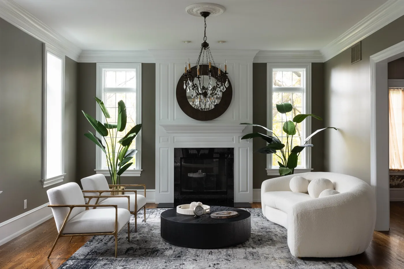 Living room with sculptural furniture and a black marble fireplace